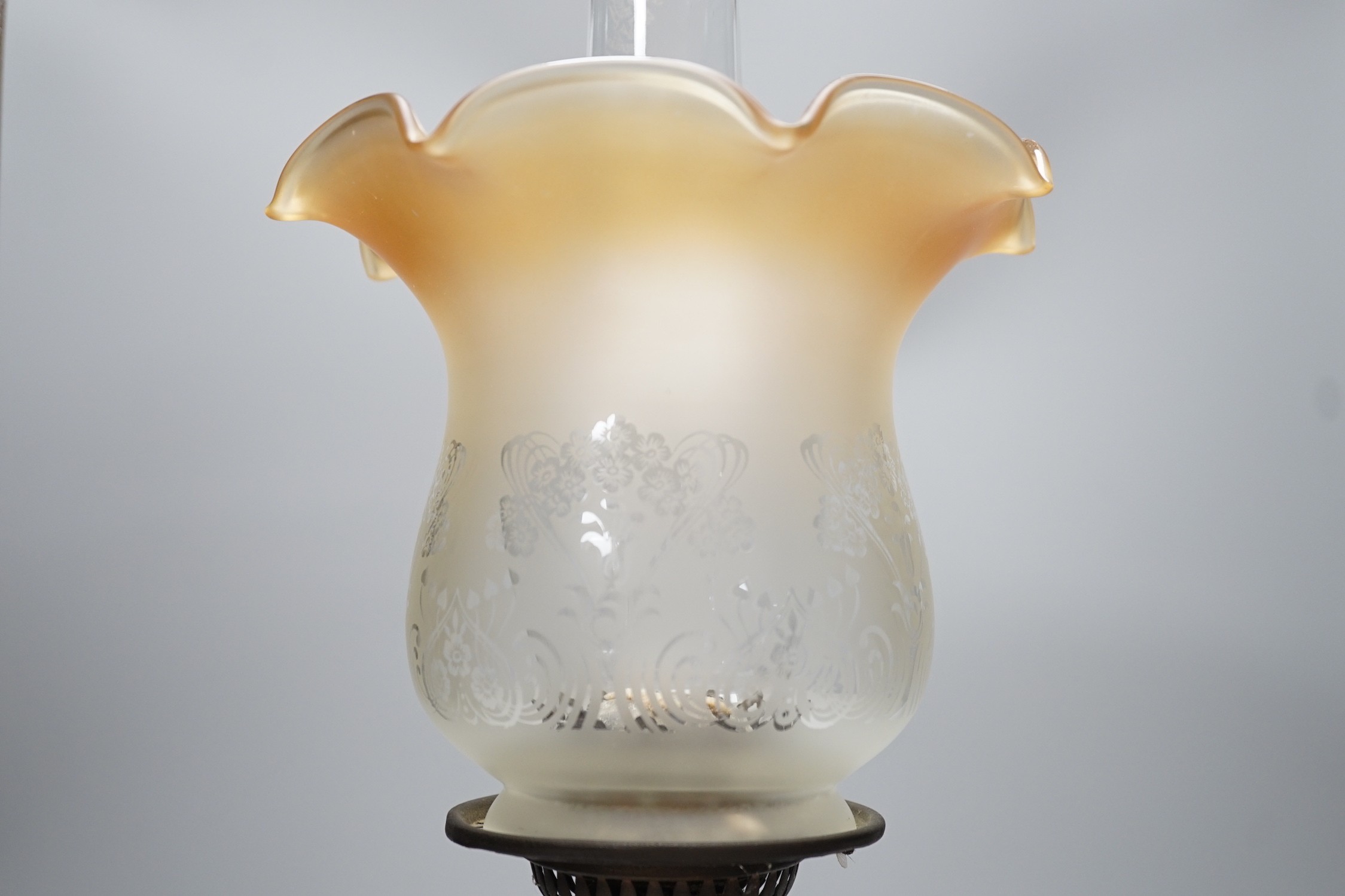 A Victorian brass stemmed oil lamp and glass shade, 50cms including shade